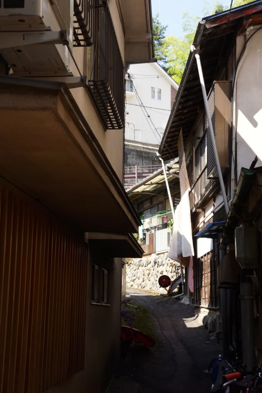 an alley with laundry hanging off the balconys