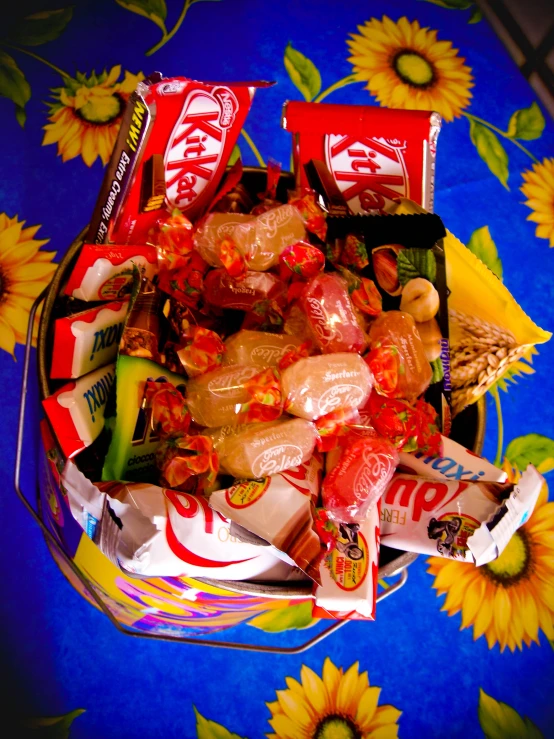 a bowl of candies, corn and pop cans