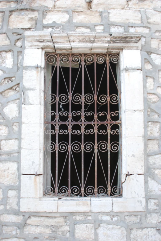 a wrought iron window over the door in an old building