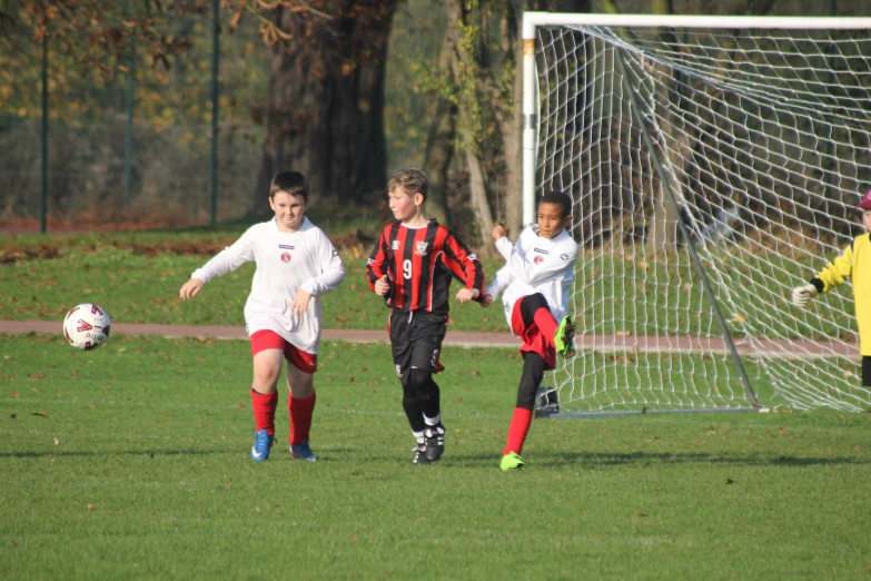 two boys playing soccer with two others