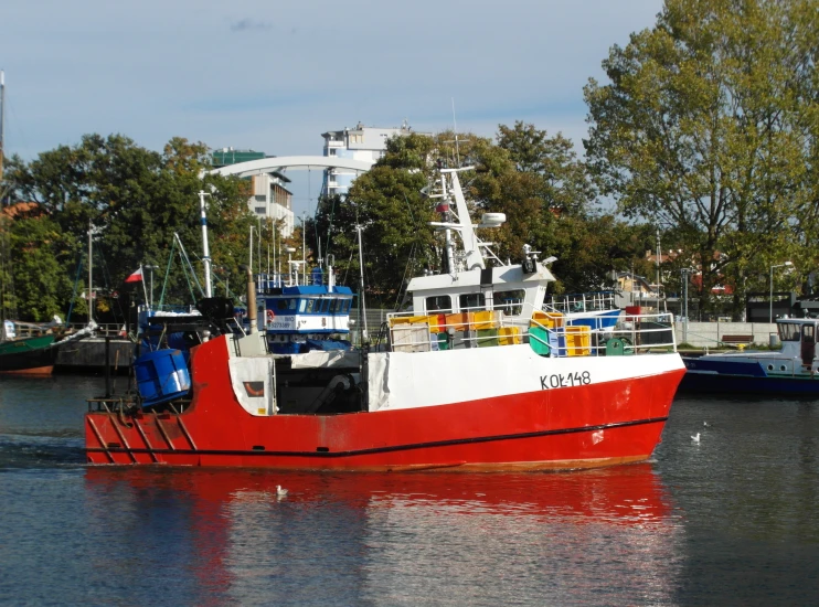 the fishing boat is traveling through the river