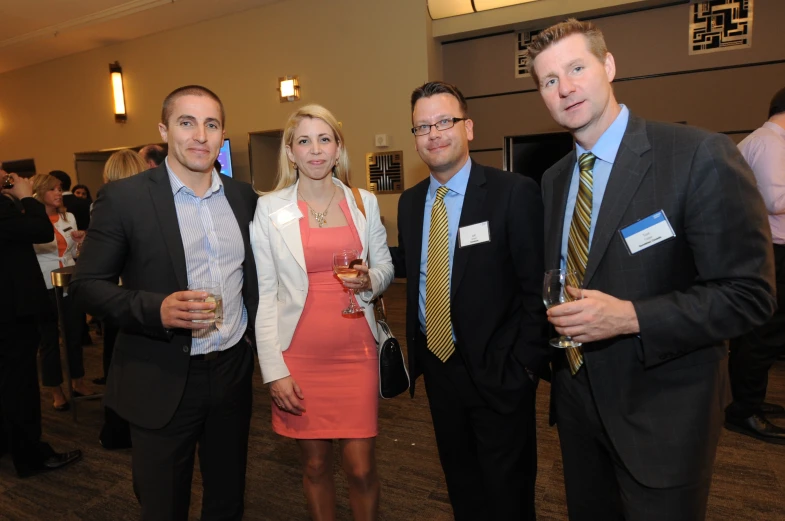 several business people standing in line for a picture