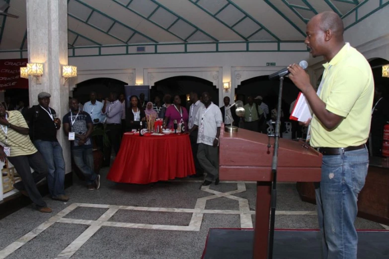 a man is speaking at an event in a building