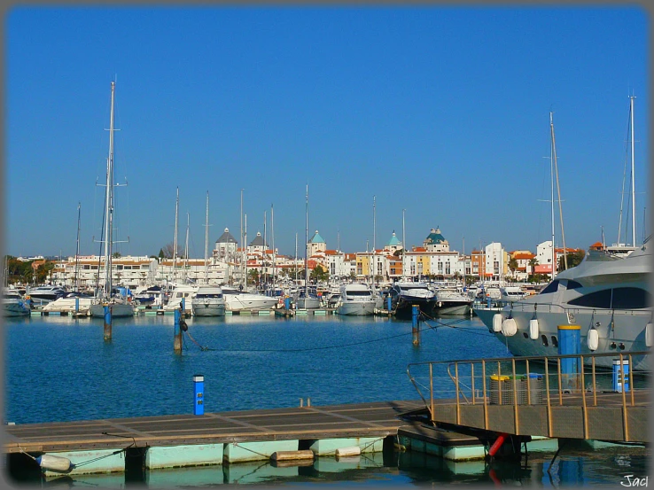 the docks with several sailboats are in a large city