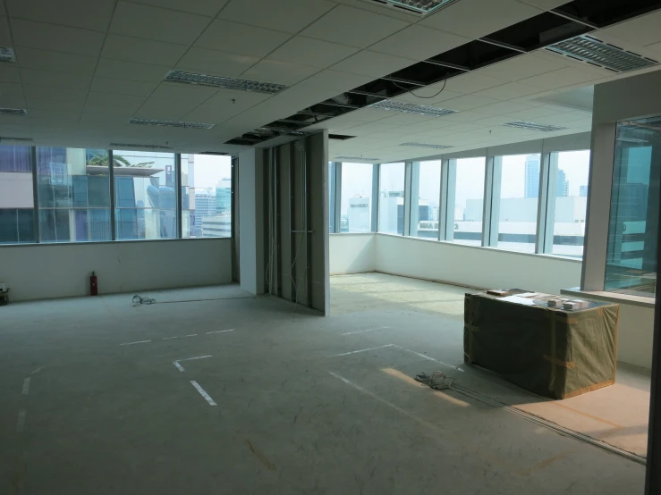 an empty room with large windows near the ceiling