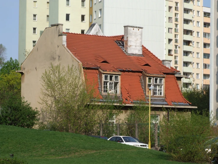 the house is surrounded by several apartment buildings