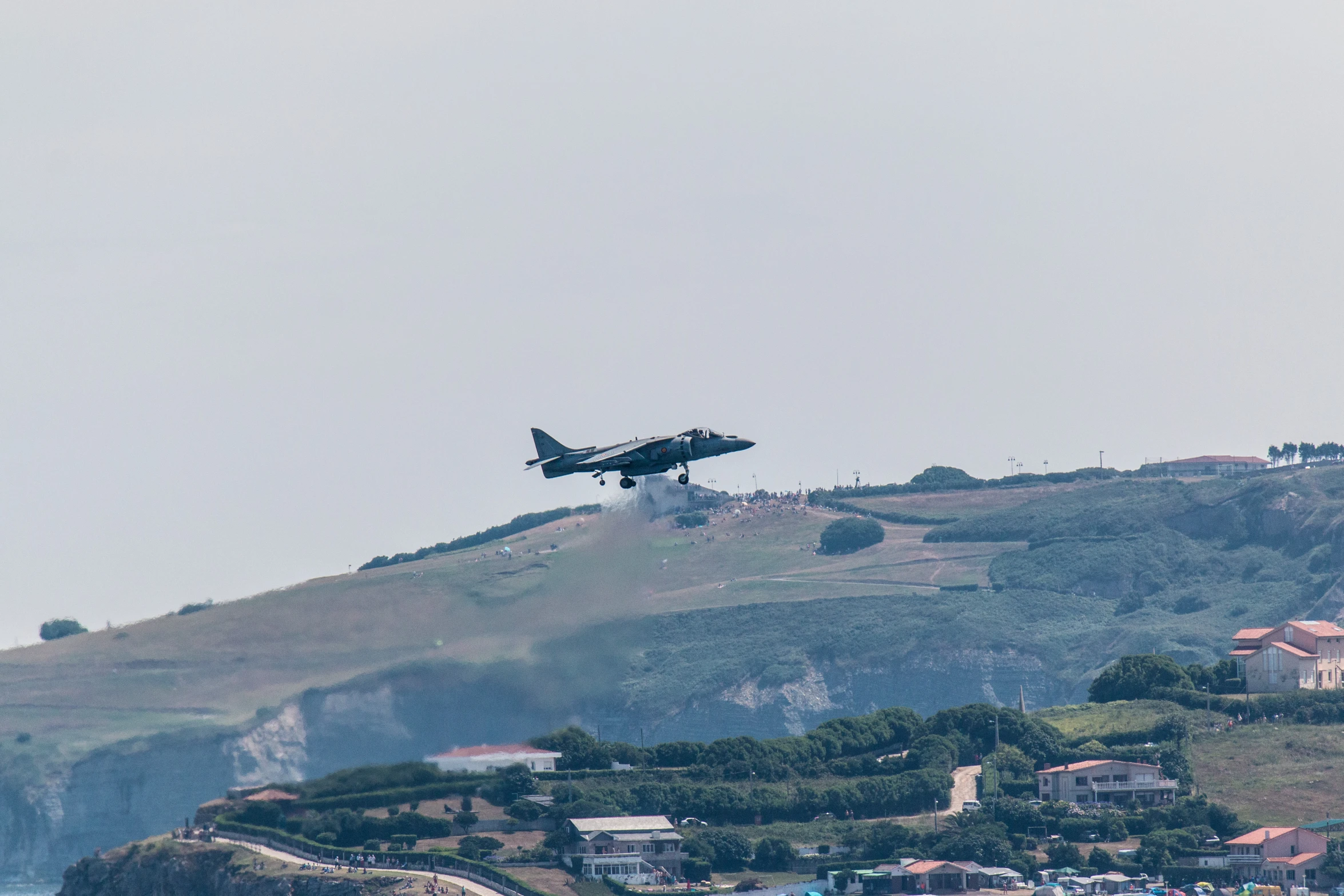 an airplane flying high over a town