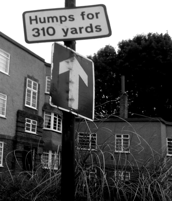 a pole with a street sign sitting in front of a building