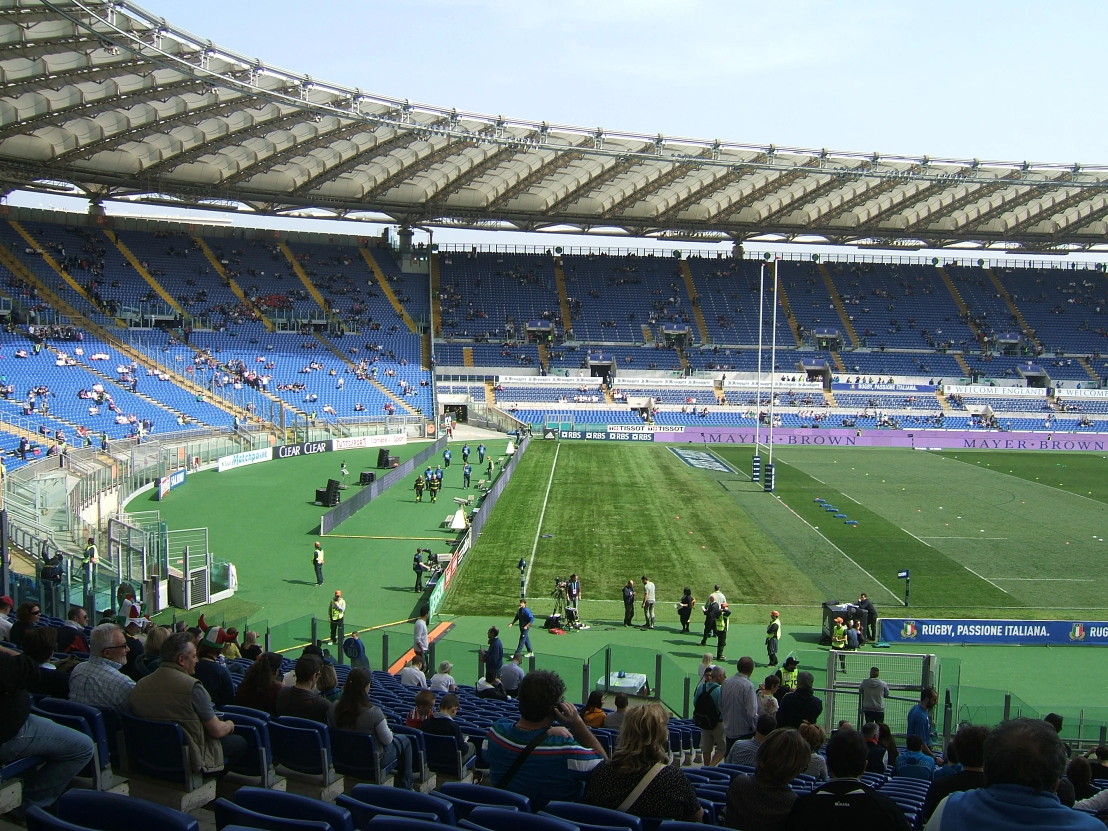 soccer players and fans sitting around the goal posts