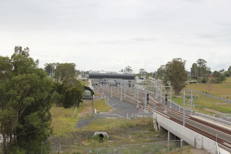 a train coming down the tracks in an industrial area