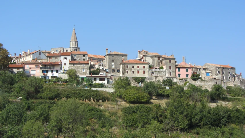 a city on a hill surrounded by trees