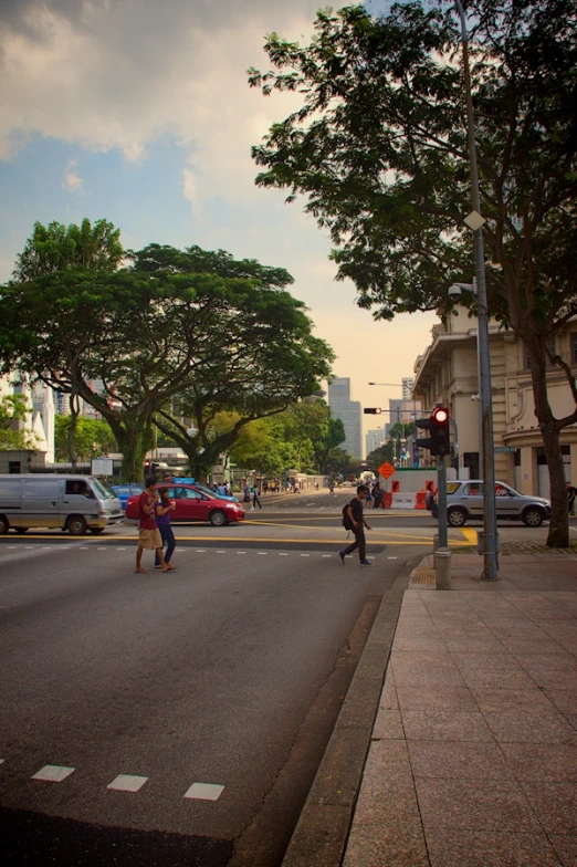 two people crossing an intersection in a city