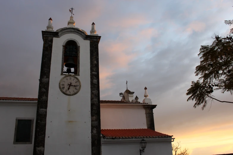 a building has a tall clock tower with a bell tower at the top