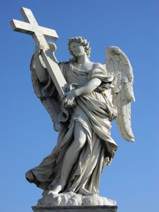 the statue has wings holding a cross