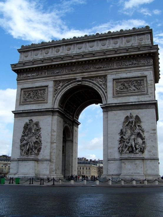 people are standing by the monument, looking at it