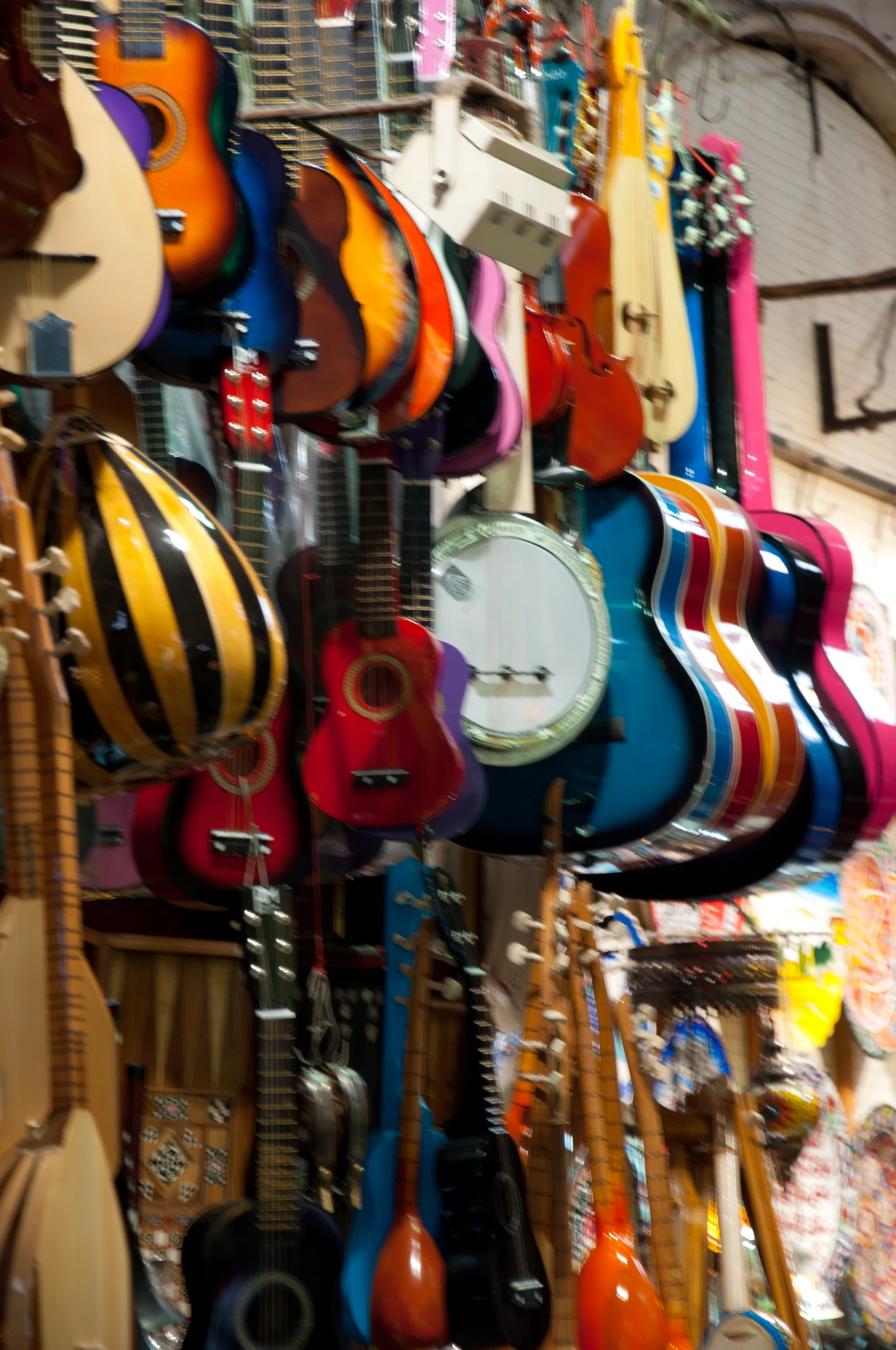 guitars hanging on the wall and some guitar clocks