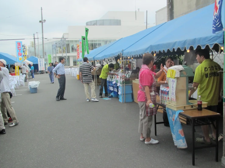 several people at booths with lots of food