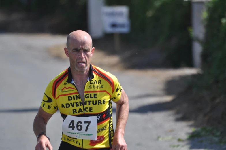 a man in yellow shirt running in a marathon