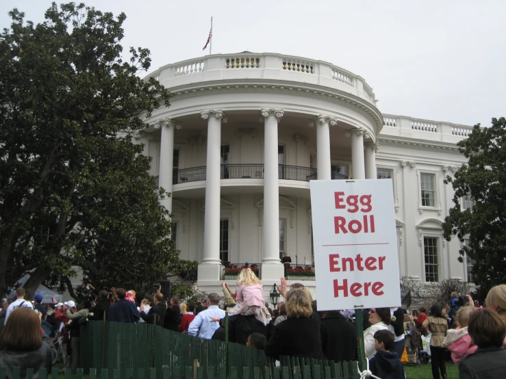 people gathered in front of the white house with signs