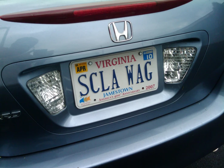 the rear view of a blue honda car with the word scla hag written on it