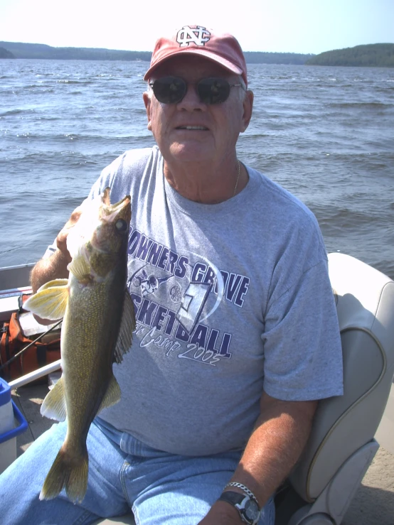 the old man is fishing on the boat