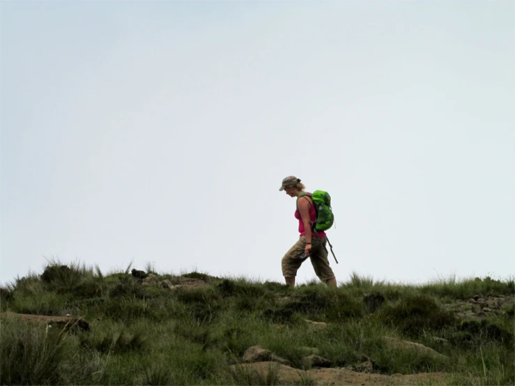 a person is hiking through the hills with a backpack