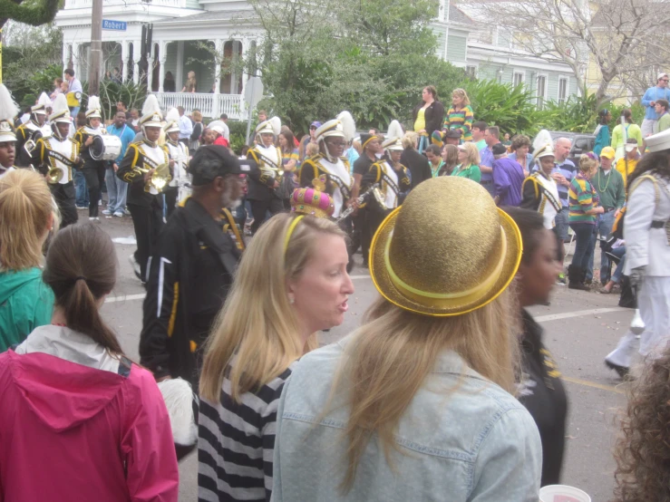 women and men in costume walk on a street