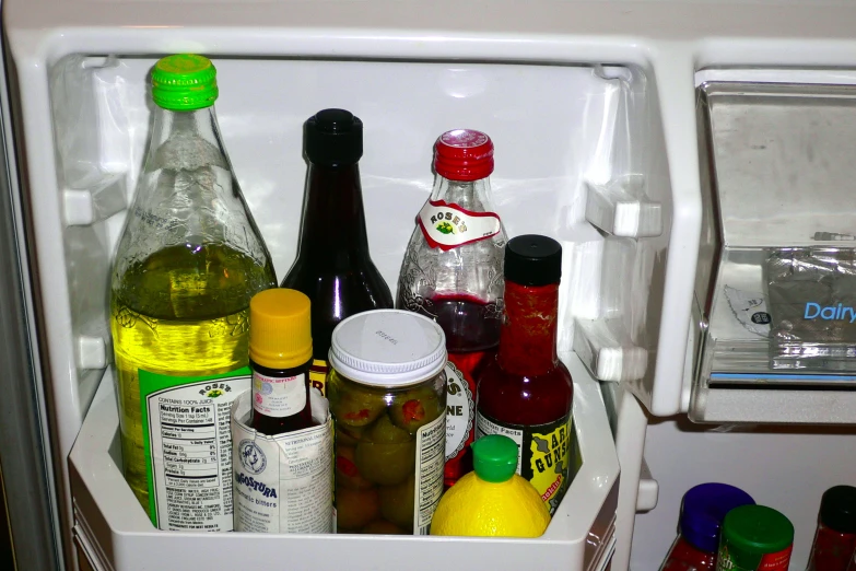 there are many bottles in the bottom of the refrigerator