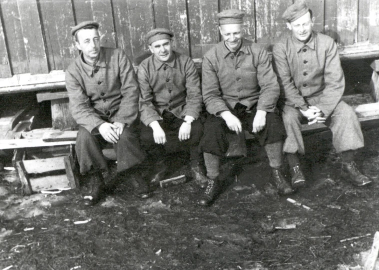 an old time po shows four men sitting down