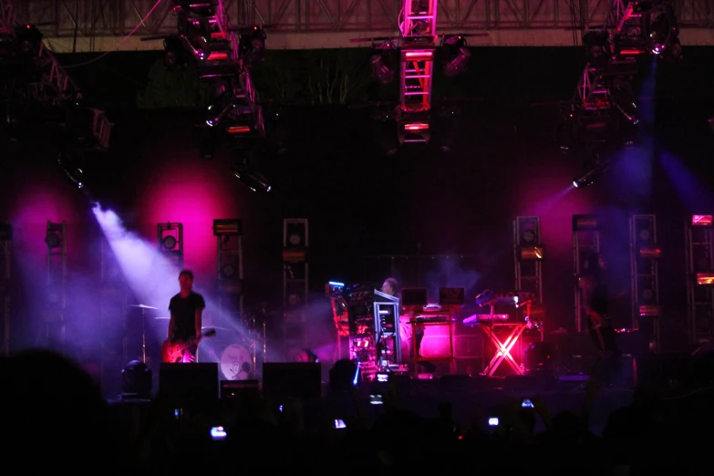 a stage with purple lighting and purple smoke