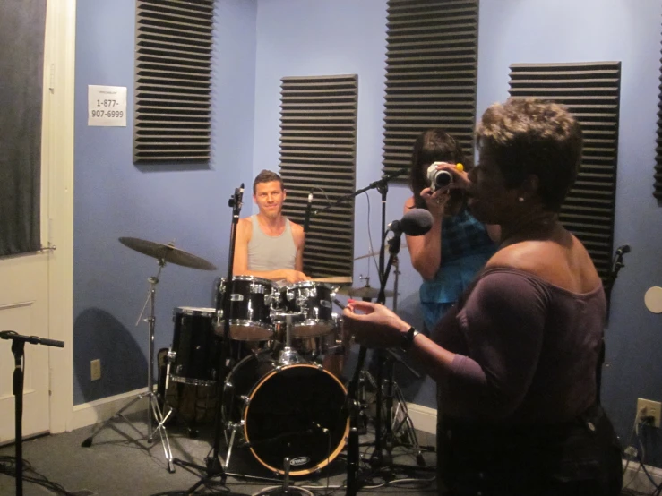 man and woman recording music in a blue room