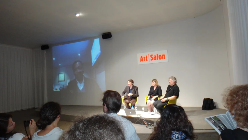 a group of people sitting in front of a projection