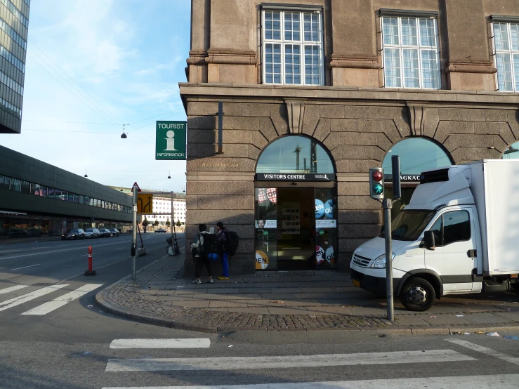 there is a truck that is parked in front of a store