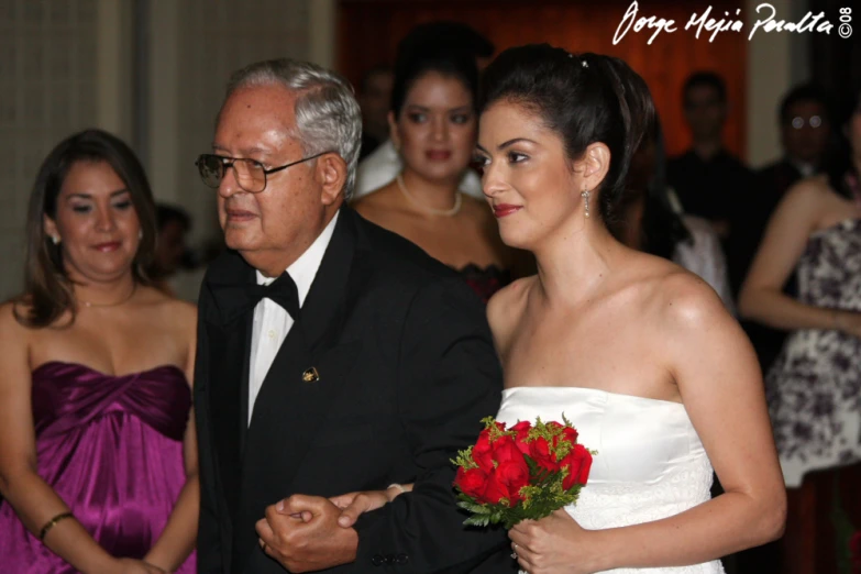 a man in a tuxedo and a woman in a wedding dress