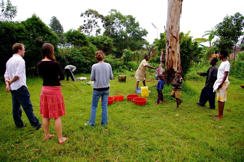 the people are playing with buckets in the field