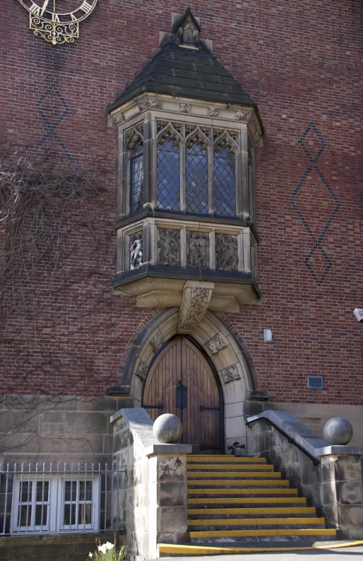 the entrance to a large red brick building with steps leading up to it