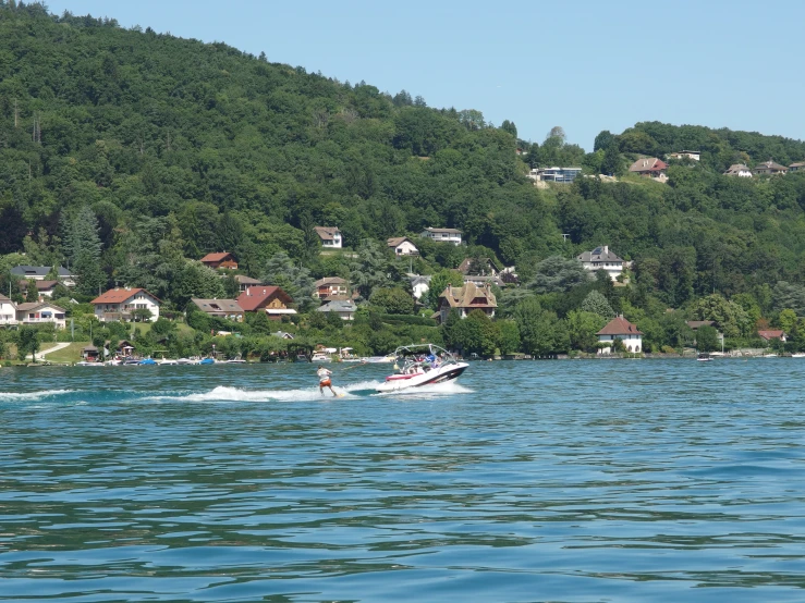 a man is water skiing near a village