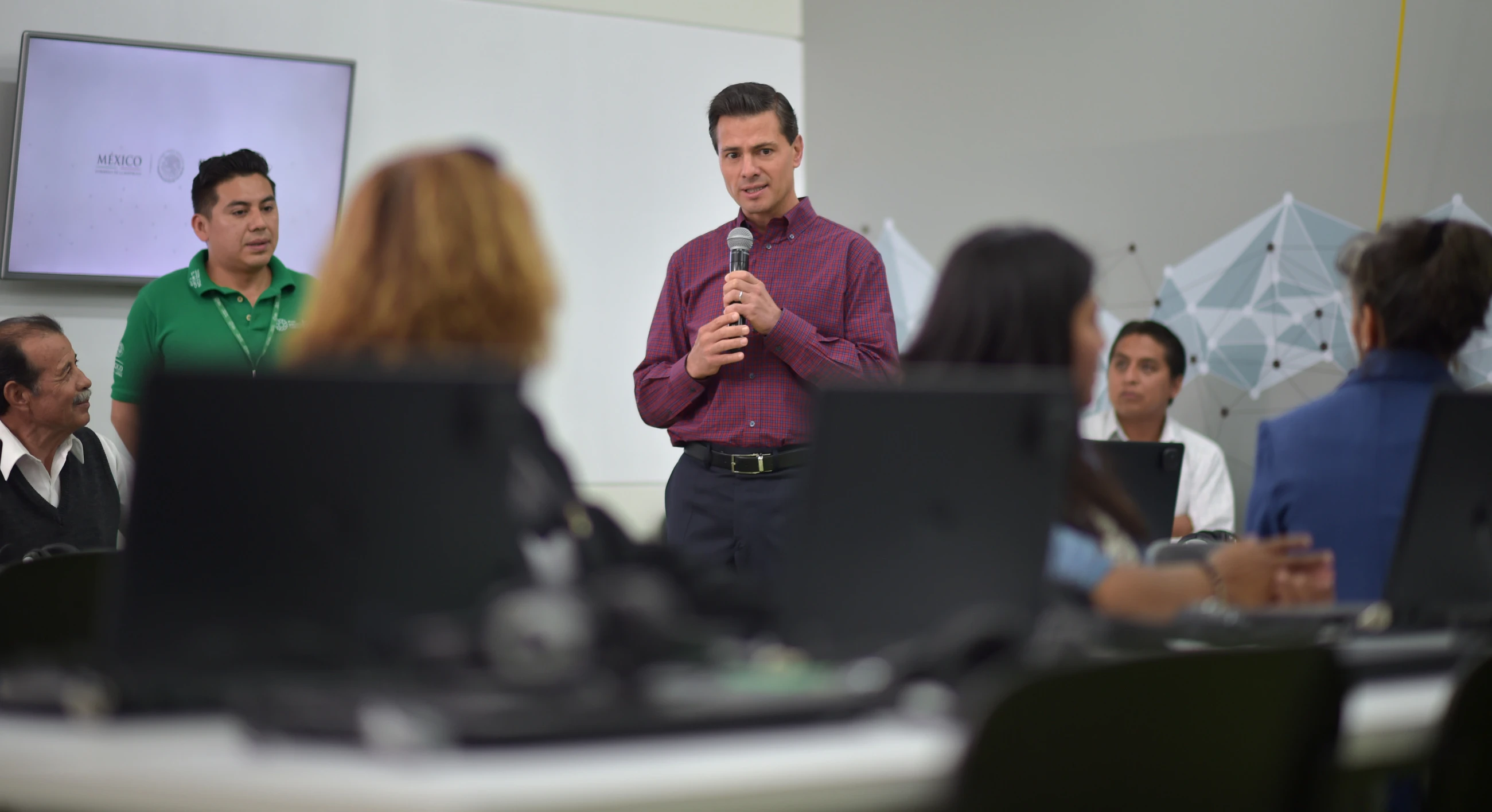 the man is making a speech to his colleagues