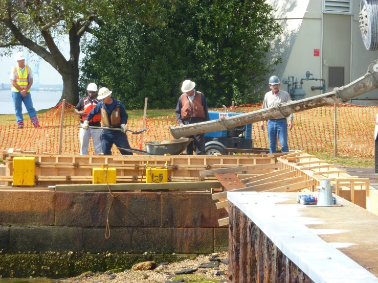 a group of construction workers fixing a wooden beam