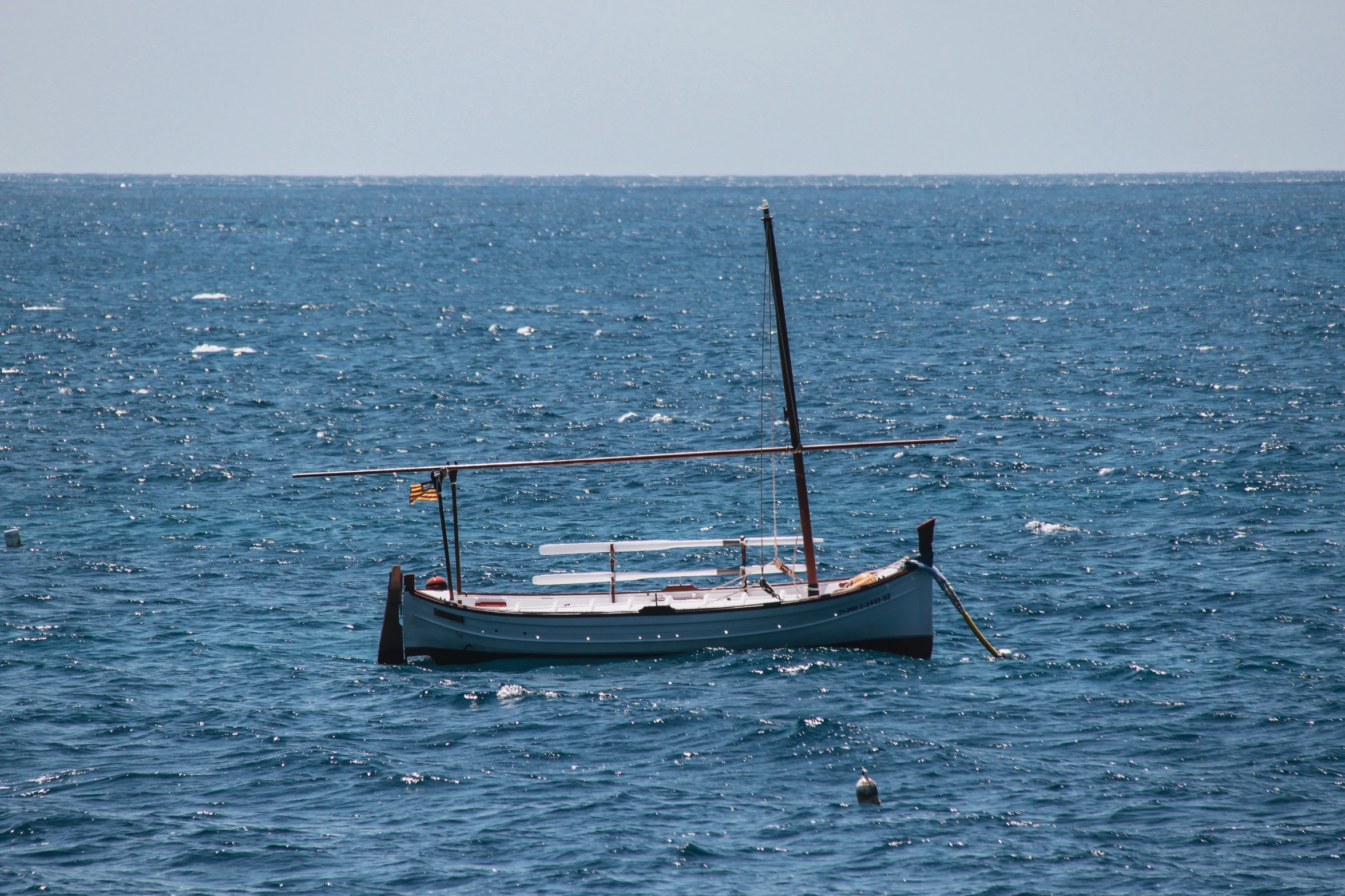 a small boat in the middle of a body of water