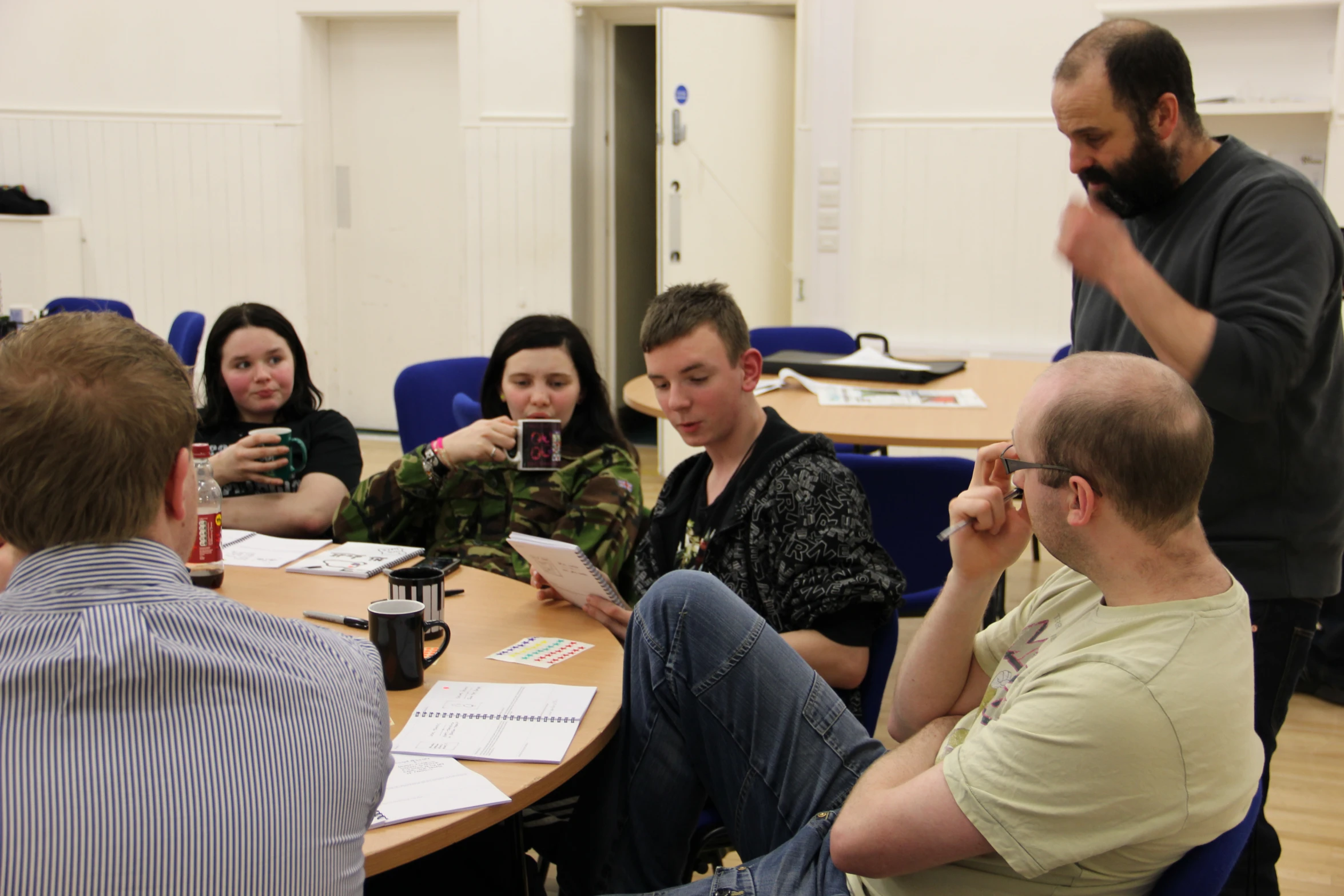 people sitting at a table looking at papers