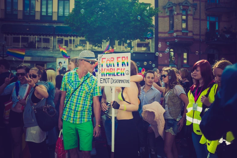 two people are on the street holding a sign