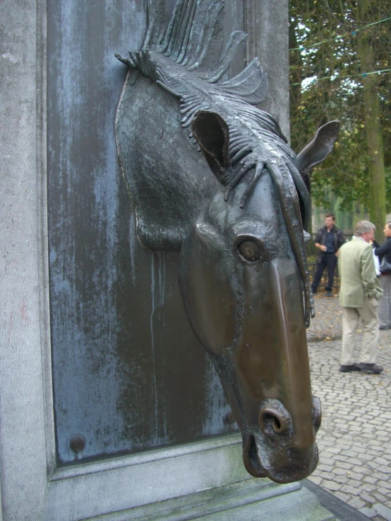a horse head is mounted on a stone surface