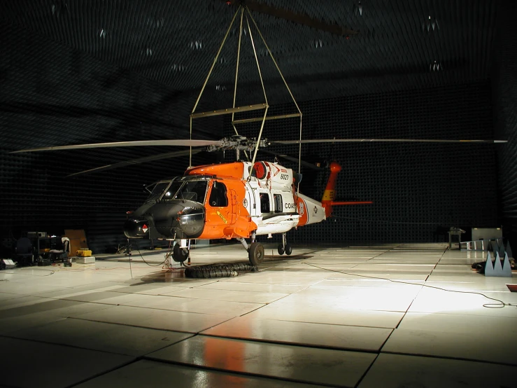 a helicopter suspended on chains in the middle of a building