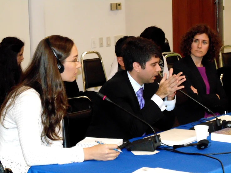 a group of people sitting at a blue table