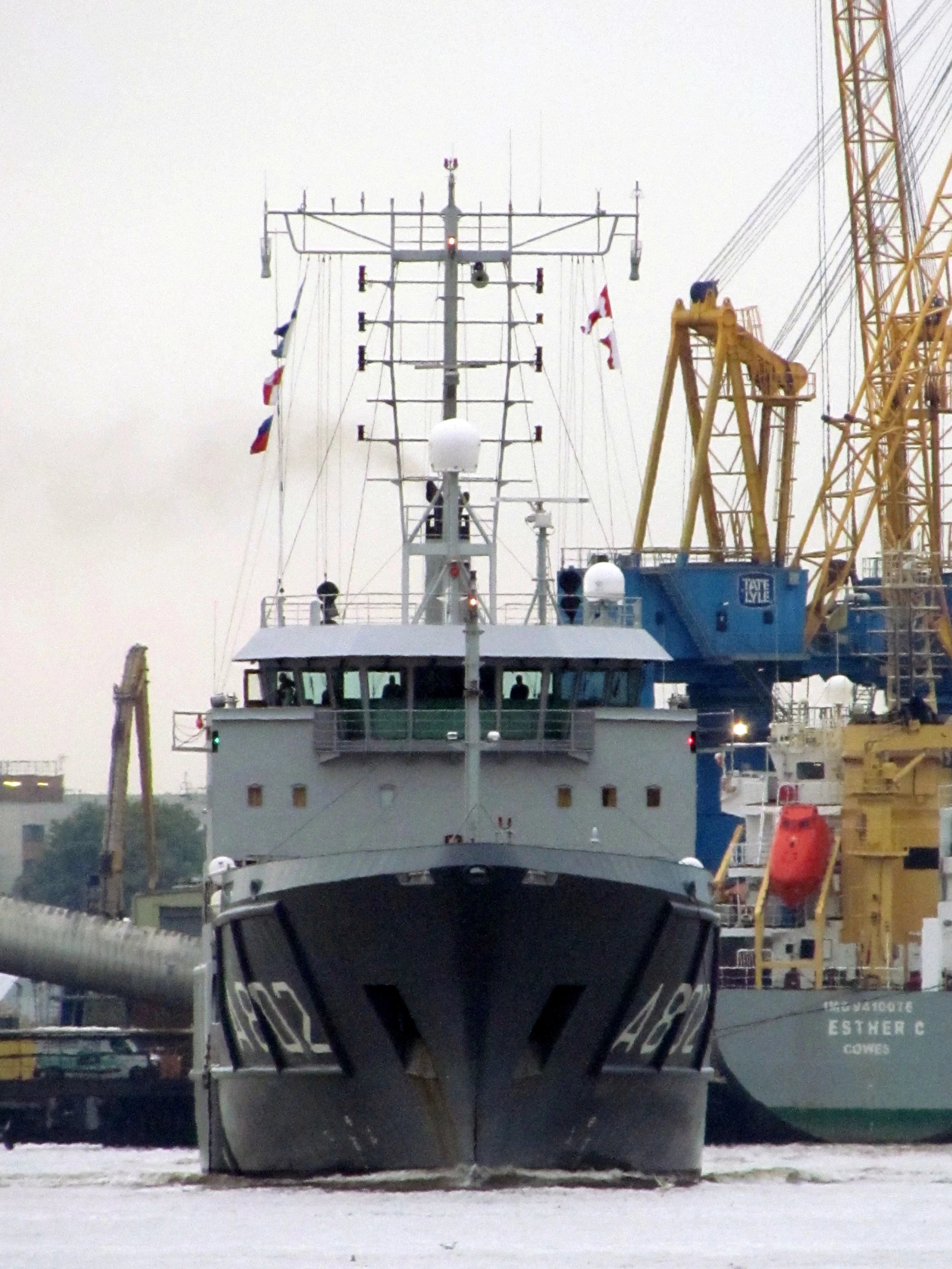 there are several ships and large cranes near each other