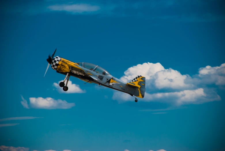 an old fashioned air craft in flight on a sunny day