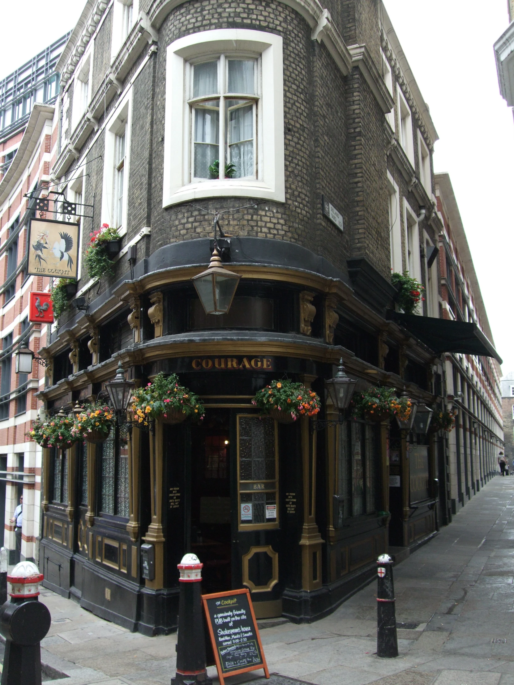 a large building with flowers on it is on the corner