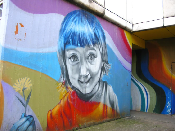 a child painted on a large wall with yellow flower