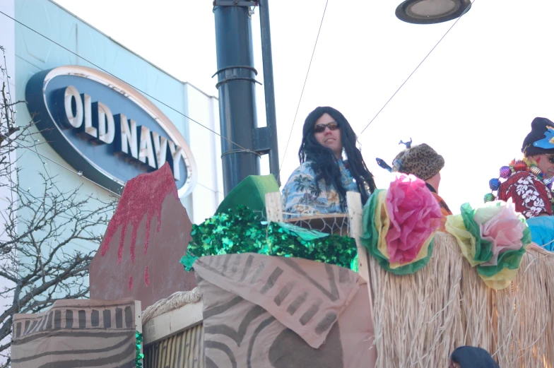 several women dressed in costumes riding a float